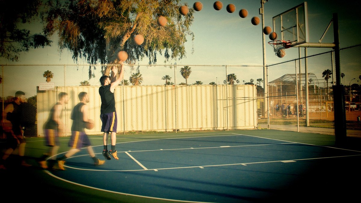 Real photo: many frames of one jump shot combined, showing the path of the ball.