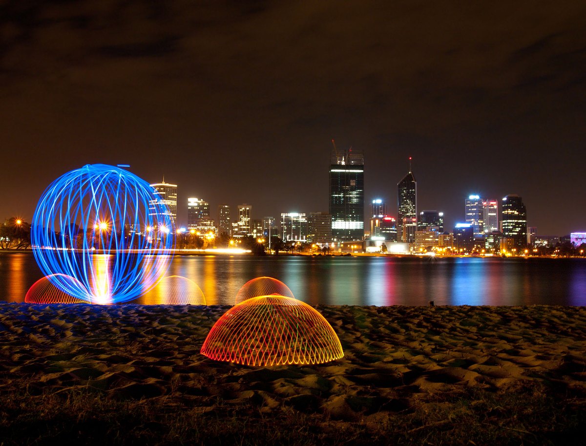 Real light painting: glowing shapes drawn with lights during a long exposure.