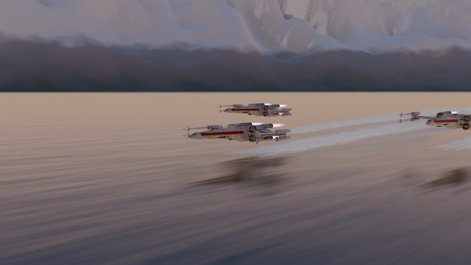 Three X-wing fighters in a V formation fly low over a calm lake at dawn, leaving white wakes, with snowy mountains behind