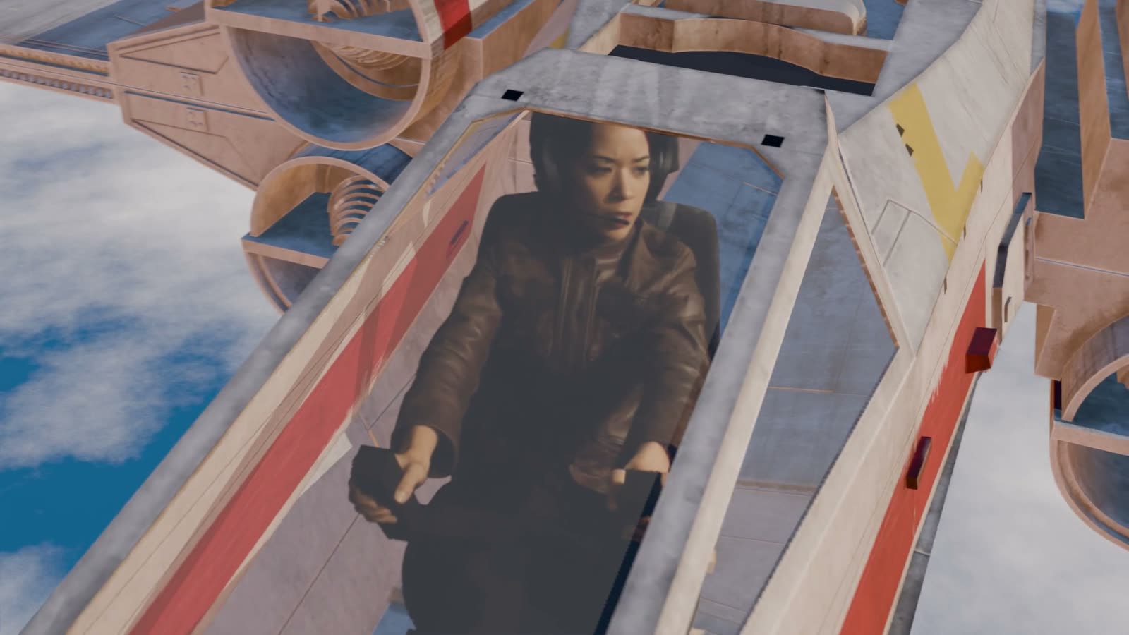 A pilot in a brown jacket and headset sits in the cockpit of a white and red fighter above clouds, seen from above